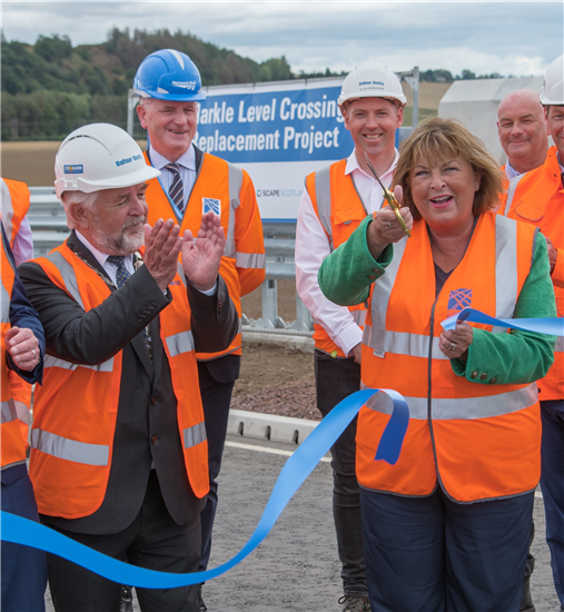 John McMillan applauds as Fiona Hyslop cuts the ribbon